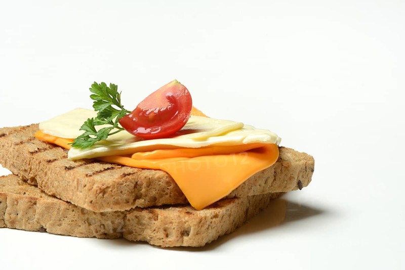 Processed cheese, slices of processed cheese on toast and tomato