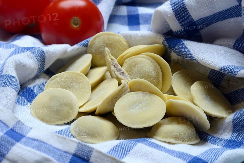 Anolini, filled pasta pockets on kitchen towel, pasta variety from Italy, Anolini piacentini