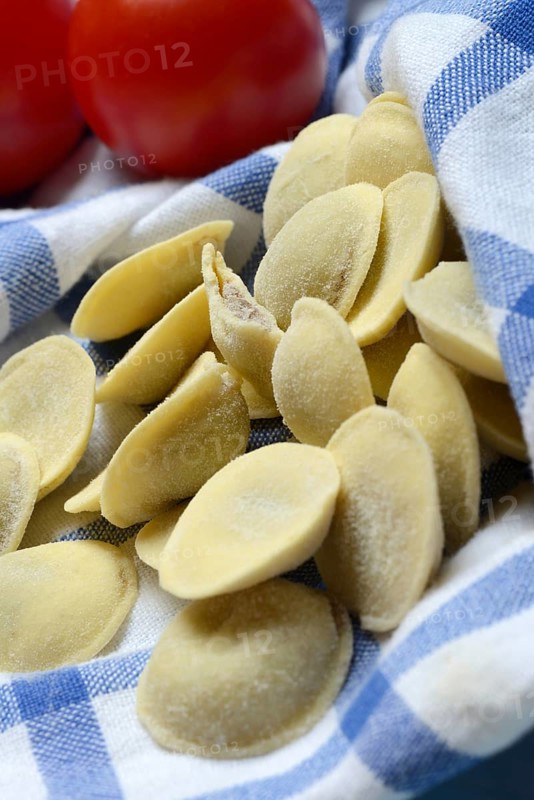 Anolini, filled pasta pockets on kitchen towel, pasta variety from Italy, Anolini piacentini
