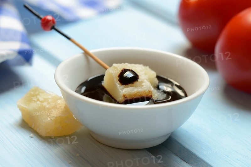 Parmesan cheese, pieces of cheese with crema di balsamico in small bowls