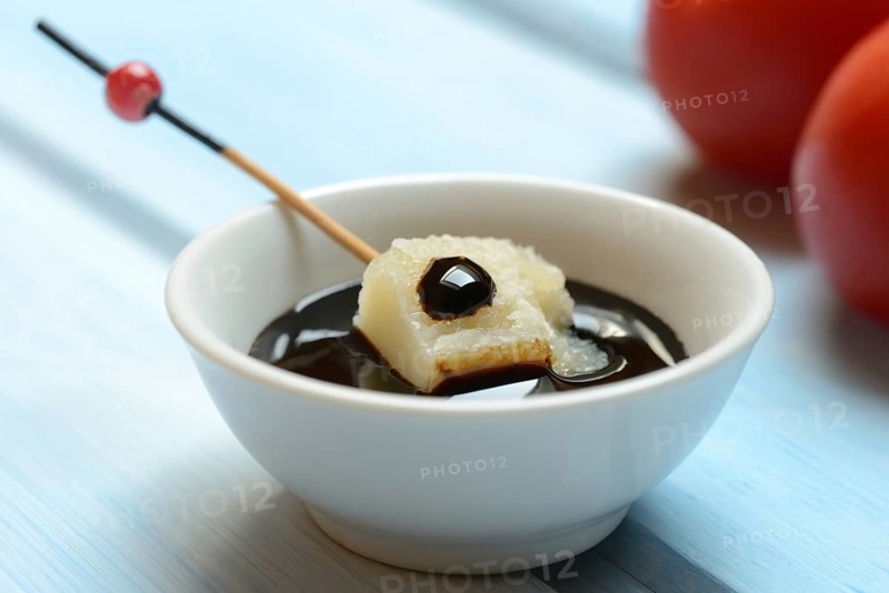 Parmesan cheese, pieces of cheese with crema di balsamico in small bowls