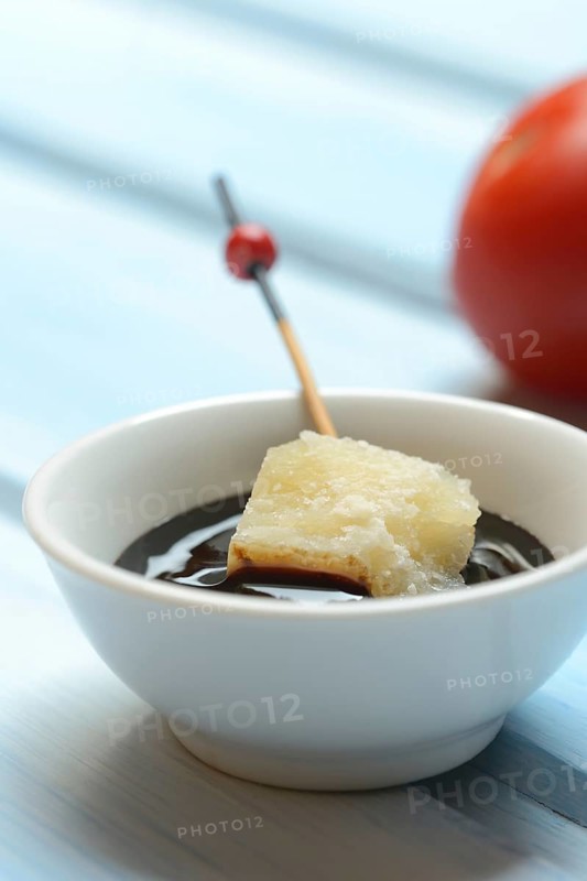 Parmesan cheese, pieces of cheese with crema di balsamico in small bowls
