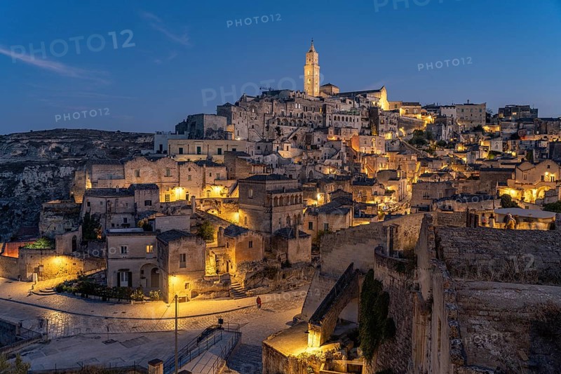 City view of Matera with the Sassi cave settlements and the cathedral at dusk, Matera, Basilicata, Italy