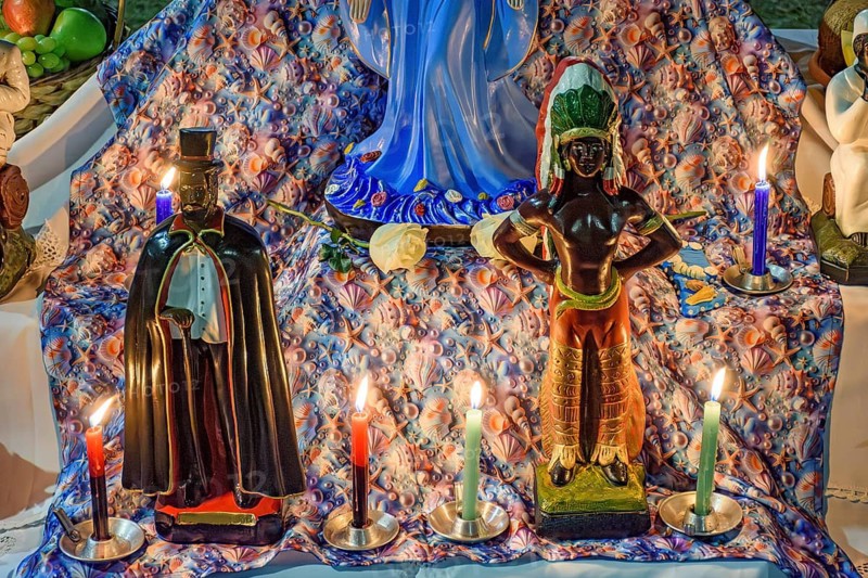 Umbanda altar with its deities and objects of worship lit by candles at night, Belo Horizonte, Minas Gerais, Brazil