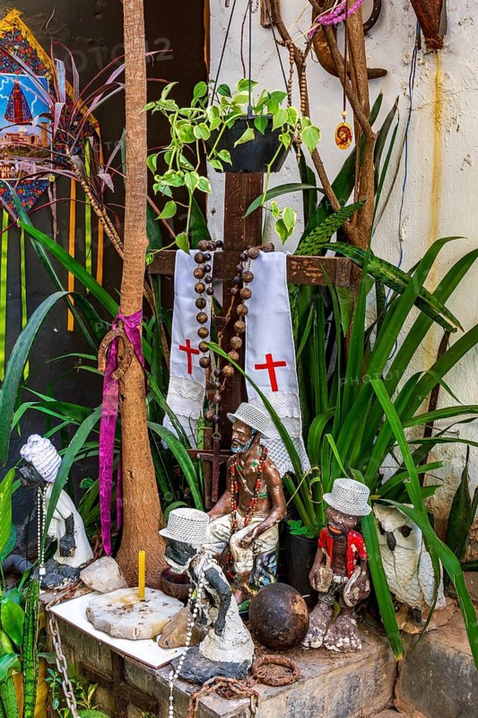 Religious syncretism of Umbanda and Cotolicism mixed on an altar among the plants, Belo Horizonte, Minas Gerais, Brazil