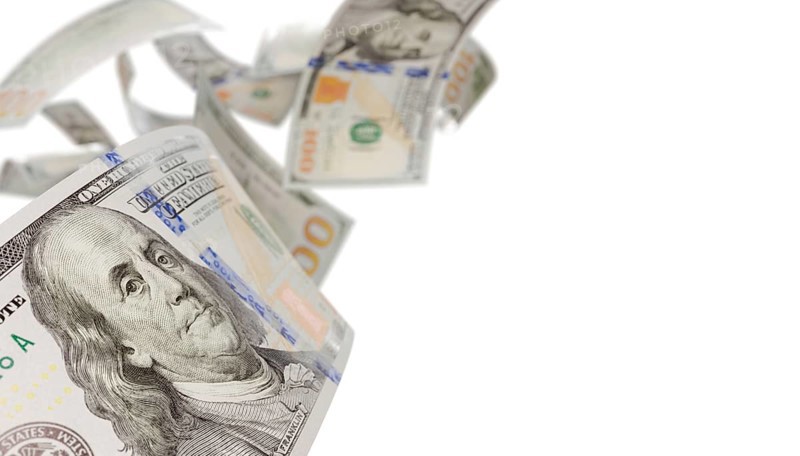 Randomly falling U.S. 100 dollar bills isolated on a white background