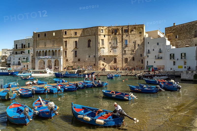 Blue Gozzi fishing boats in the old harbour of Monopoli, Apulia, Italy