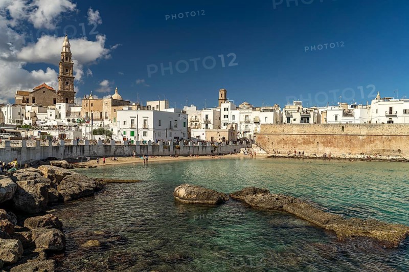 City view of Monopoli with the cathedral, city wall and the beach Cala Porta Vecchia, Apulia, Italy