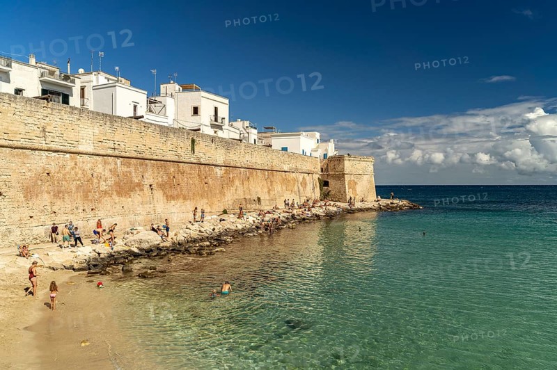 City wall and Cala Porta Vecchia beach in Monopoli, Apulia, Italy