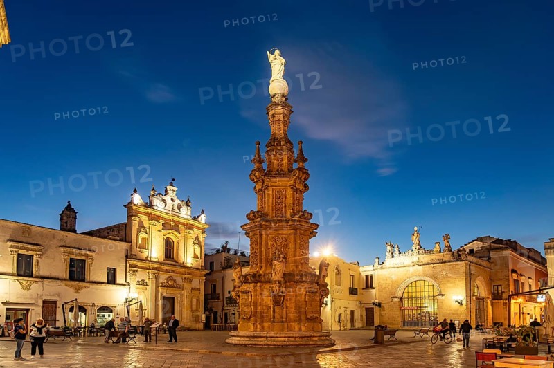 The Piazza Salandra square with the Guglia dell'Immacolata column and the Chiesa di San Trifone church at dusk, Nardo, Apulia, Italy