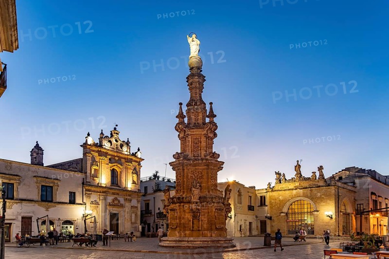 The Piazza Salandra square with the Guglia dell'Immacolata column and the Chiesa di San Trifone church at dusk, Nardo, Apulia, Italy