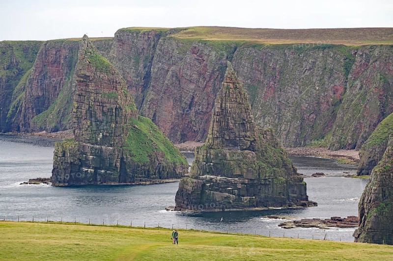 Majestic coastal cliffs surrounded by green grass and the sea, Duncansby Stacks, Thurso, Old Town, Calton Hill, Edinburgh, Scotland, United Kingdom
