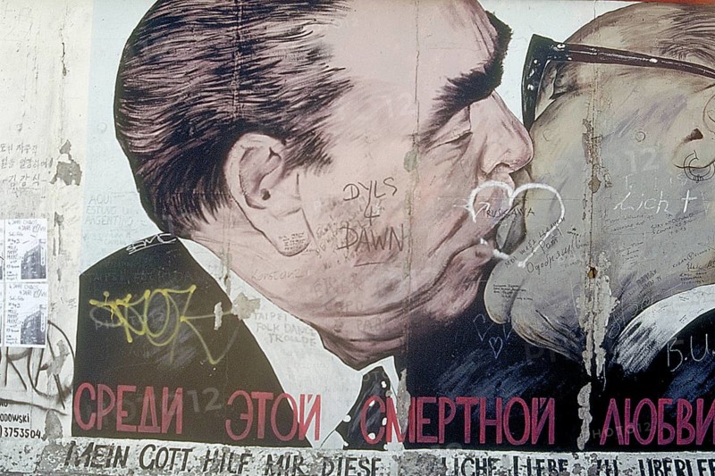 Artwork shows Leonid Brezhnev and Erich Honecker kissing, painting was created in 1990 at the Berlin Wall, Berlin, Germany