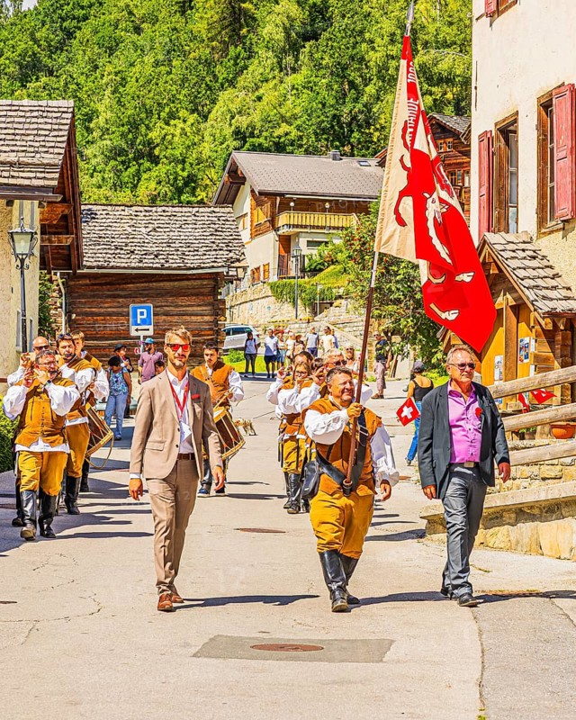 Drummers' and pipers' meeting in Mission, here the entry of a music group led by a standard-bearer, Val d'Anniviers, Valais Alps, Canton Valais, Switzerland