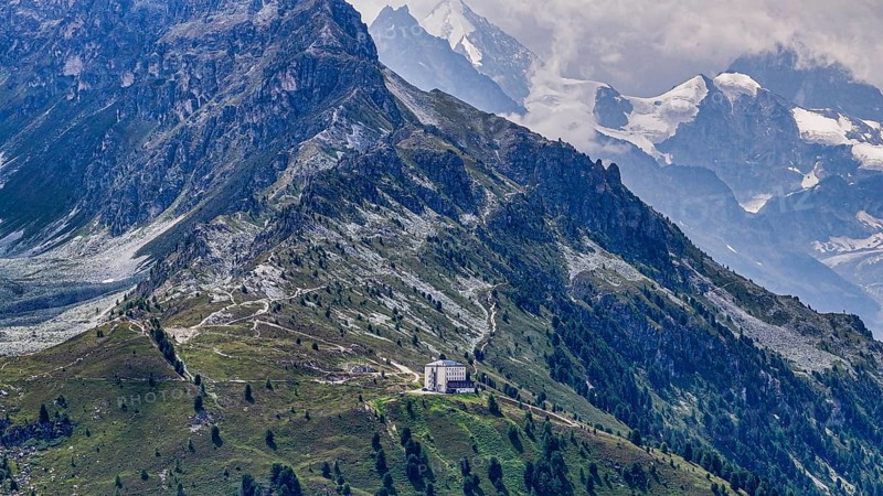 The historic Hotel Weisshorn below the Weisshorn mountain, behind the four-thousand-metre peaks and glaciers in clouds, above the mountain village of Zinal, drone shot, Val d'Anniviers, Valais Alps, Canton Valais, Switzerland