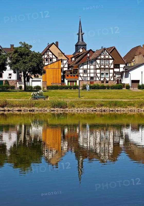 View over the river Weser to the old town centre of Bodenwerder with the church tower of St. Nicolai, Weserbergland, Lower Saxony, Germany
