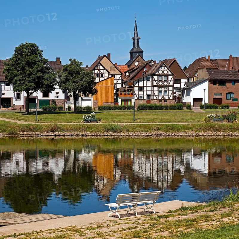 View over the river Weser to the old town centre of Bodenwerder with the church tower of St. Nicolai, Weserbergland, Lower Saxony, Germany