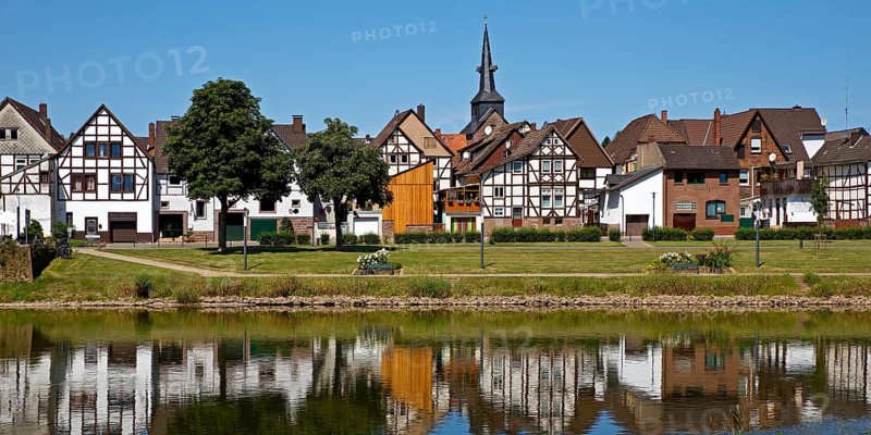View over the river Weser to the old town centre of Bodenwerder with the church tower of St. Nicolai, Weserbergland, Lower Saxony, Germany