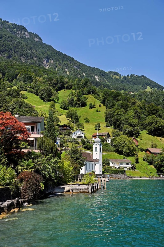 View of the village with the Roman Catholic Church of St Idda, Lake Lucerne in the background, Bauen, Canton, Uri, Switzerland