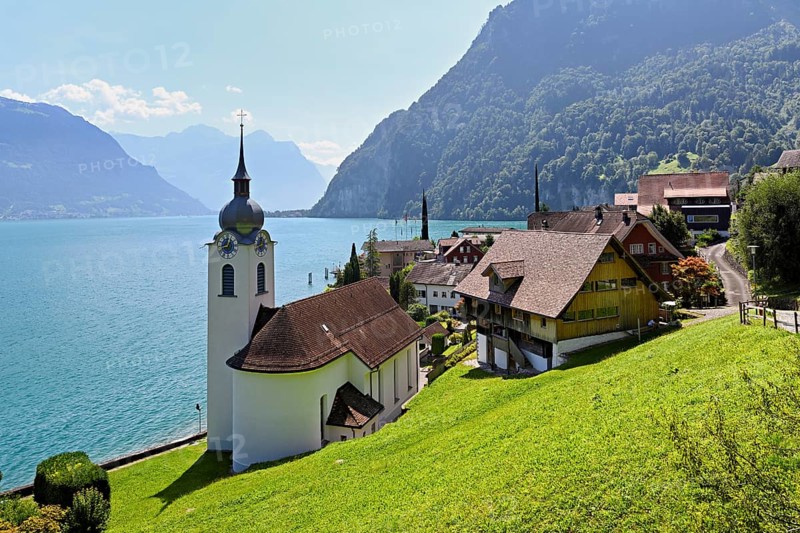 View of the village with the Roman Catholic Church of St Idda, Lake Lucerne in the background, Bauen, Canton Uri, Switzerland