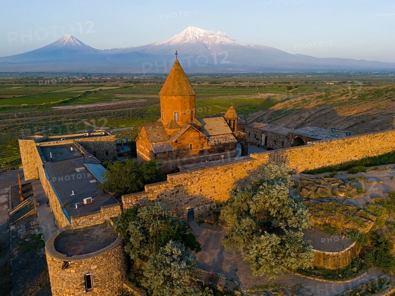 A historic monastery in the morning light in front of Mount Ararat, aerial view, Chor Wirap monastery, Chor Virap, deep dungeon, in the background Mount Ararat and Little Ararat, located in Turkey, Ararat province, Armenia