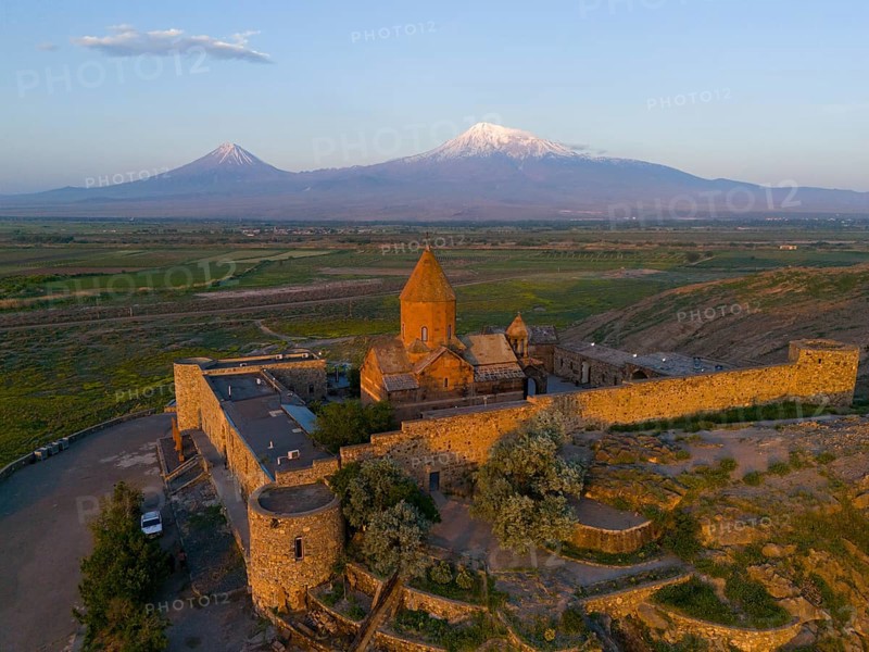 Historic monastery with surrounding wall and view of Mount Ararat at sunrise, aerial view, Chor Wirap monastery, Chor Virap, deep dungeon, in the background Mount Ararat and Little Ararat, located in Turkey, Ararat province, Armenia