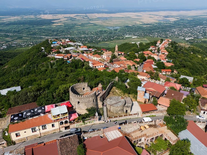 Historic town with a castle and red roofs, situated on a green hill with a wide view, aerial view, tower of the town wall, Sighnaghi, Signagi, Kakheti Province, Greater Caucasus, Georgia, Near East