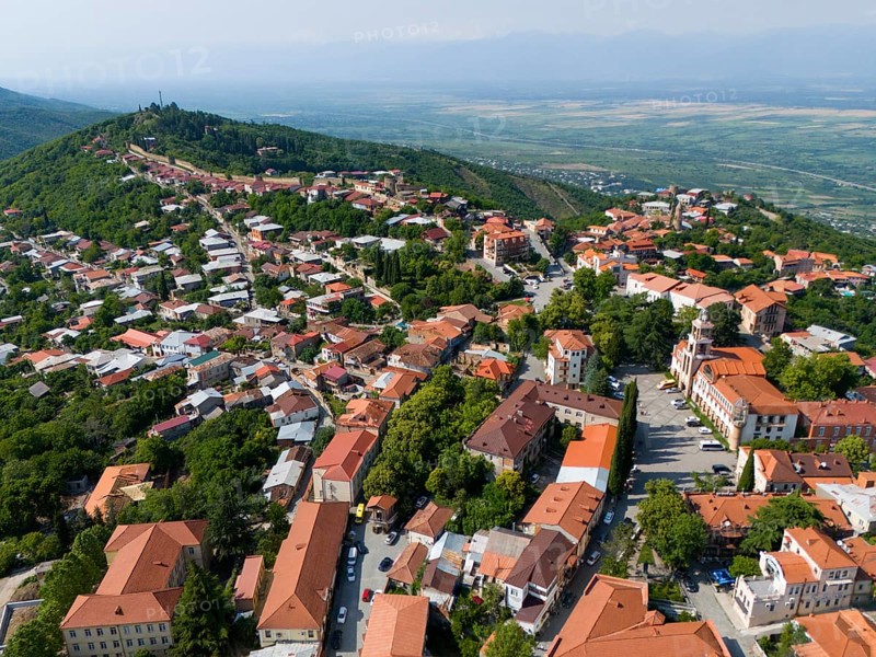 Aerial view of a hilly town with red roofs and green trees surrounded by a vast landscape, aerial view, Sighnaghi, Signagi, Kakheti Province, Greater Caucasus, Georgia, Near East