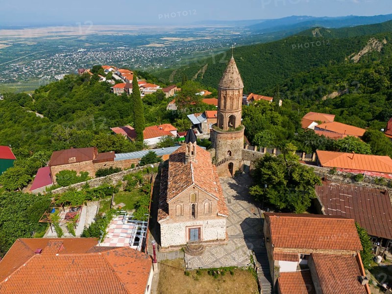Historic church with tower in a village surrounded by mountains with red tiled roofs, aerial view, Church of St George, St George, Sighnaghi, Signagi, Kakheti Province, Greater Caucasus, Georgia, Near East