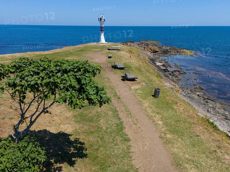 Path leading to a lighthouse on the coast, surrounded by trees and benches in a summer landscape, aerial view, Yason Burnu lighthouse, Cape Jason, Çaytepe, Ordu province, Turkey