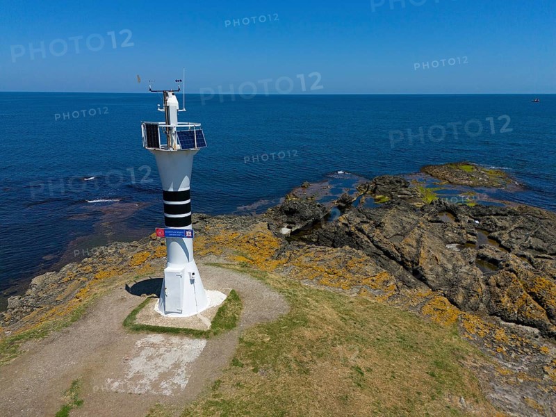 Close-up of a lighthouse on a rocky coast with the wide sea and blue sky, aerial view, Yason Burnu lighthouse, Cape Jason, Çaytepe, Ordu province, Turkey