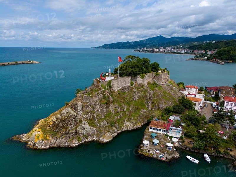 Castle on a rock formation near coastal houses and mountains with clouds, aerial view, fortress, castle, Tirebolu, Giresun Province, Black Sea, Turkey