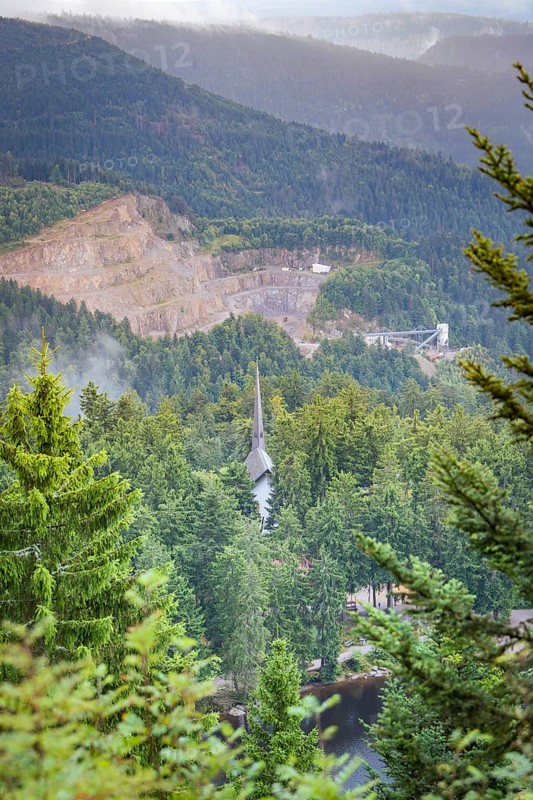 View over a wooded valley with mountain scenery and buildings between the trees, Mummelsee, Seebach, Ortenau District, Black Forest, Germany
