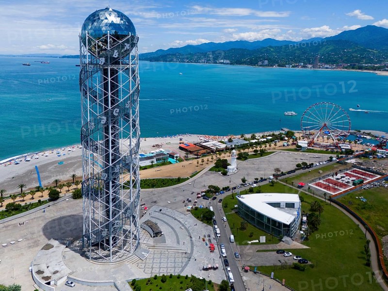 Steel construction tower overlooking the sea, Ferris wheel and surrounding coastline on a sunny day, aerial view, Alphabetic Tower, Georgian Alphabet Tower, Miracle Park, Batumi, Black Sea, Adjara region, Adjara, Autonomous Republic, Georgia