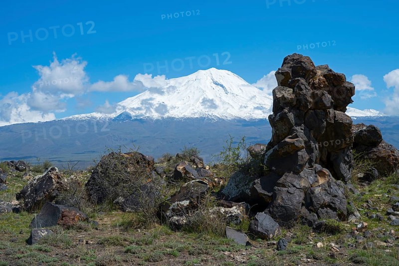 Snow-covered mountain under blue sky with clouds, surrounded by rocks and green landscape, aerial view, landscape near Demirtepe, Great Ararat, Büyük Agri Dagi, Dogubayazit, Dogubayazit, Dogubeyazit, Agri Province, Agri, Eastern Anatolia, Anatolia, Turkey