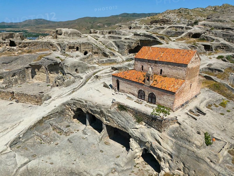 Fascinating ruins of Uplistsikhe with orange tiled roofs in the middle of a rocky landscape, aerial view, Princes' Church, Uplistsikhe cave town, Uplistsikhe, Inner Kartlia region, Shida Kartli, Georgia