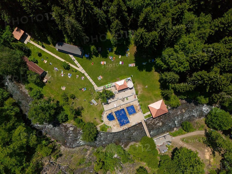 Aerial view of a forest area with swimming pool, river and surrounding buildings, surrounded by dense nature, aerial view, outdoor swimming pool, sulphur springs of Borjomi, Borjomi, Samtskhe-Javakheti region, Kura river, Lesser Caucasus, Georgia
