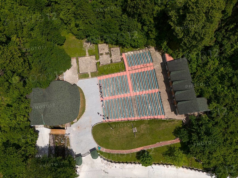 A bird's eye view of an amphitheatre with seats embedded in a wooded landscape, aerial view, Green Theatre, Tsageri, Racha-Lechkhumi region and Lower Svaneti, Georgia