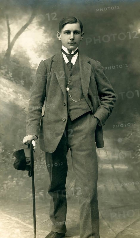 Elegant young man with hat and walking stick, studio photograph, around 1910