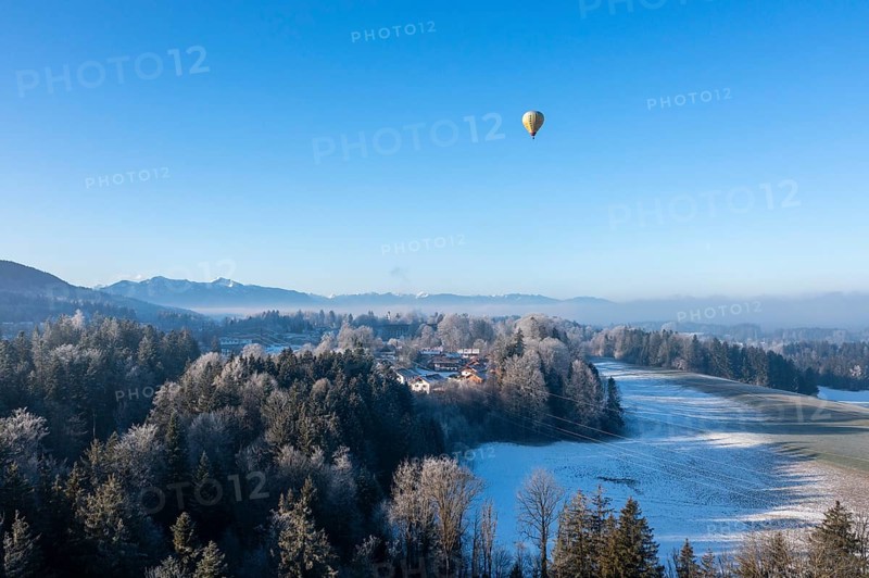 Hot air balloon in winter over Bad Heilbrunn, Upper Bavaria, Bavaria, Germany