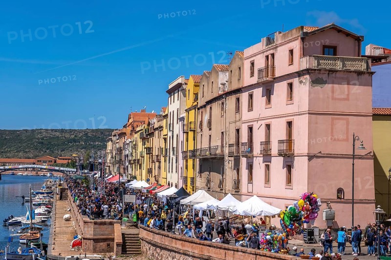 Sardinia, boats in the river Temo and houses on the promenade, guests at the restaurants with outdoor catering, Bosa, Europe, Province of Oristano, Italy, architecture, atmosphere, view, outdoor catering, visitor infrastructure, boats, relaxation, food, river Temo, riverbank, leisure, spring, buildings, guests, facades, culture, noon, seagulls, promenade, travel, restaurants, restaurant terraces, sightseeing, summer, sun, cityscape, tourism, tourists, waterfront, holiday, means of transport, water, residential buildings, European city, Italian, local, picturesque, Mediterranean