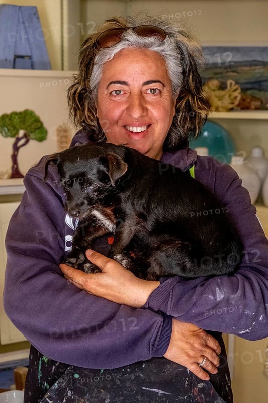 Sardinia, Pina Monne, female portrait and dog on arm, artist, Tinnura, Europe, Oristano province, Italy, arm, expression, exhibition, bond, village, woman, female portrait, gallery, face, hair, pet, dog, clothing, scenery, culture, art, artwork, painting, originality, portrait, sightseeing, talent, animal, animal friendship, tourism, domesticated, adult, European, Italian, creative, Mediterranean, regional, Sardinian, traditional, female
