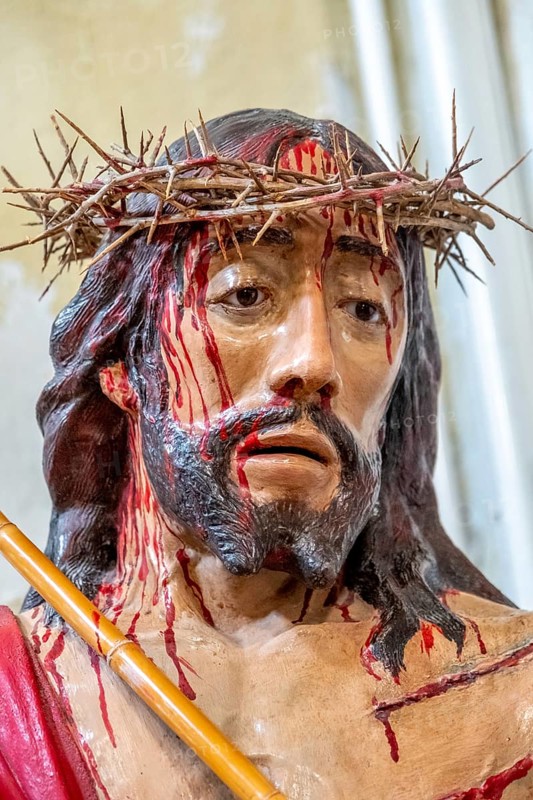 Sardinia, maltreated and bleeding face of Jesus with crown of thorns, Bosa, Europe, Province of Oristano, Italy, devotion, expression, meaning, Bible, Christianity, representation, detail, crown of thorns, narrative, figure, face, faith, God, icon, Jesus, church, crucifixion, culture, art, suffering, sacrifice, sightseeing, sculpture, symbol, tourism, tradition, bleeding, Christian, emotional, maltreated, holy, historical, cultic, religious, sacred, spiritual