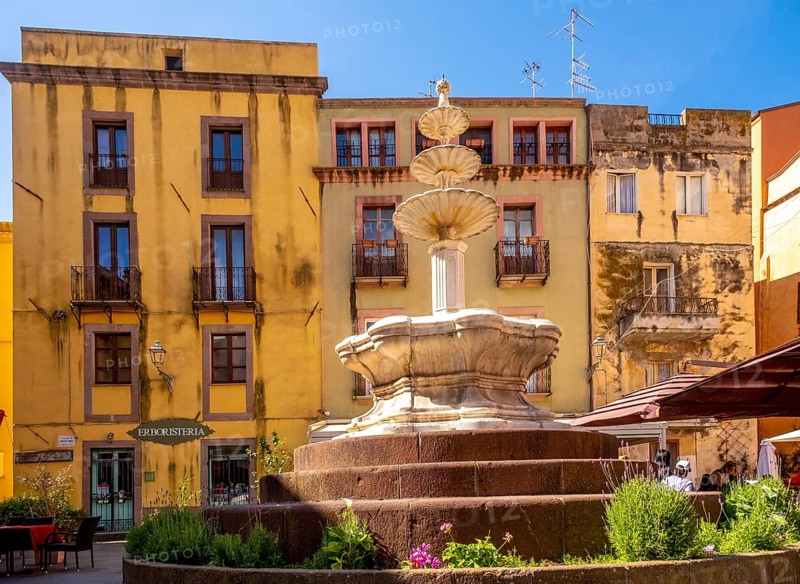 Sardinia, artistic fountain with three levels on the Piazza Costituzione, house wall with Erboristeria shop, Bosa, Europe, Province of Oristano, Italy, old town, architecture, detail, heritage, Erboristeria, pedestrian, building, shop, house wall, culture, art, shop, passer-by, Piazza Costituzione, destination, sight, sightseeing, summer, fountain, city, city centre, daylight, tourism, urban, water, everyday, decorative, three levels, historic, Italian, artistic, Mediterranean, stone, traditional, public space