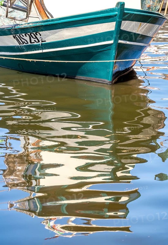Sardinia, front of a fishing boat with reflection in the river Temo, Bosa, Europe, Province of Oristano, Italy, boats, fishing boat, river, river landscape, idyll, coast, landscape, nature, navigation, reflection, journey, destination, calm, ship, sea route, sightseeing, reflection, still life, scene, daylight, Temo, tourism, front, water, Italian, picturesque, Mediterranean, calm water, sunny, traditional, warm