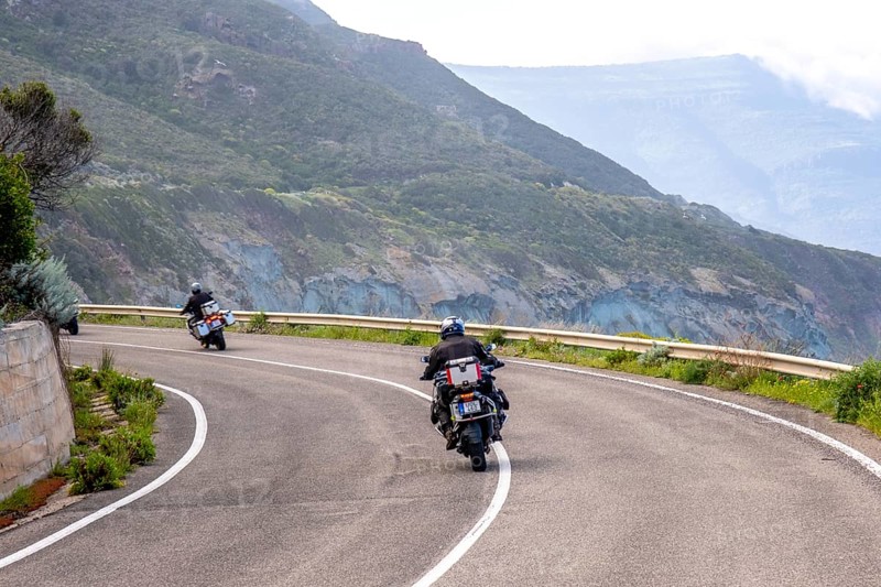 Sardinia, biker motorcyclist on the mountainous coastal road, Villanova Monteleone, Europe, Province of Sassari, Italy, adventure, asphalt, view, mountainous, movement, biker, discovery, exploration, experience, ride, airstream, vehicle, freedom, leisure, freshness, speed, helmet, sky, hills, curves, coastal road, landscape, sea view, motorcyclist, nature, outdoor, panorama, journey, traveller, protective clothing, sightseeing, summer feeling, road, day, touring, tourism, transport, holidaymaker, Italian, picturesque, vegetation
