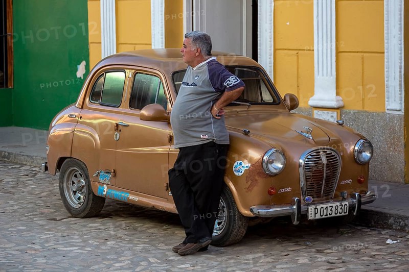 Proud car owner leaning against his small car, Trinidad, Cuba, Sancti Spíritus, Sancti Spíritus