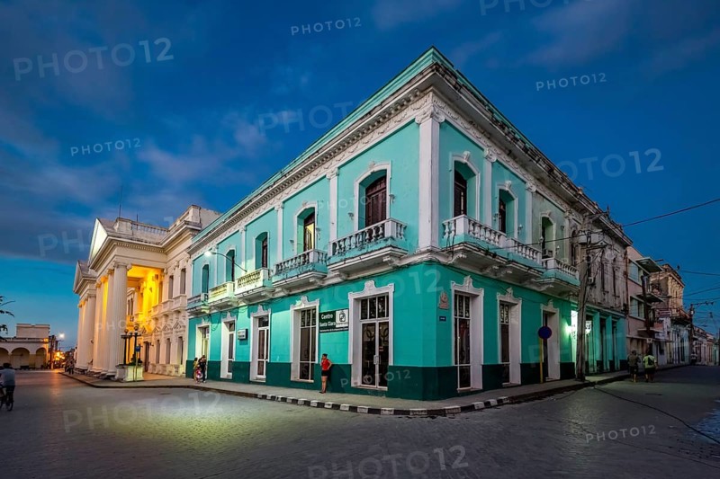 Turquoise residential building in the city centre of Santa Clara, Streetlife in the city centre of Santa Clara at the Parque de Santa Clara, Santa Clara, Cuba, Villa Clara