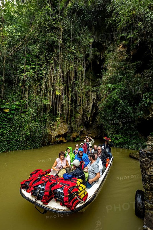 Exit of the cave system, tourists in an electric boat with life jackets, caves of the Indios, Cueva del Indio, underground caves with a watercourse river accessible to tourists, Viñales, Cuba, Central America, Cuba, Caribbean