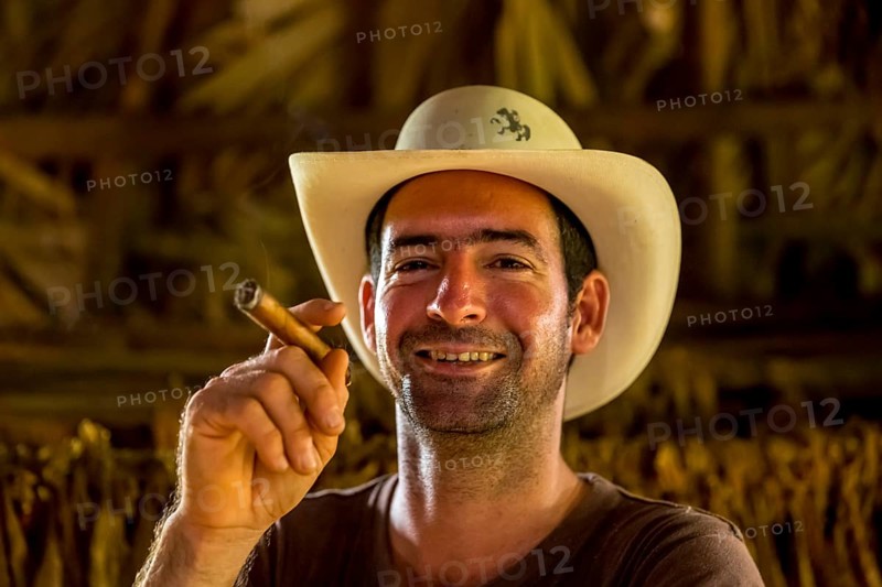 Tobacco farmer, tobacco farmer Luis Manne Alvares Rodrigues smokes a Havana cigar, tobacco farm in the Vinales Valley, Viñales, Cuba, Pinar del Río, Viñales, Pinar del Río